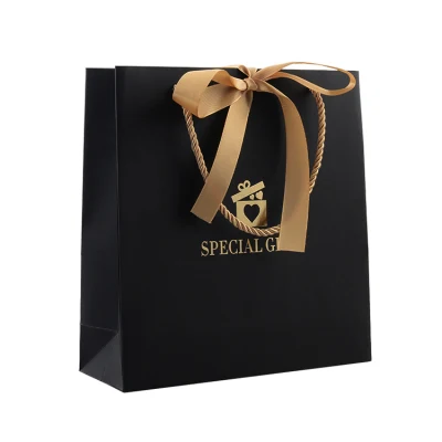  Bolsas de papel para compras personalizadas con asa de cinta de papel negro y lazo, con papel de tarjeta dorada para ropa interior, prendas de vestir, zapatos y ropa.