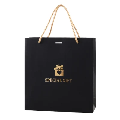 Bolsas de papel para compras personalizadas con asa de cinta de papel negro y lazo, con papel de tarjeta dorada para ropa interior, prendas de vestir, zapatos y ropa.
